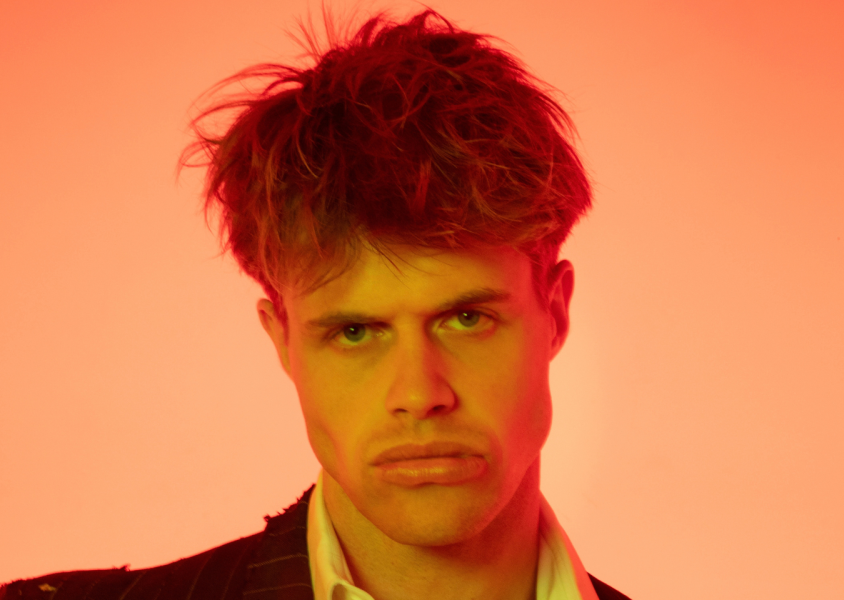 Headshot of a man with orange background x